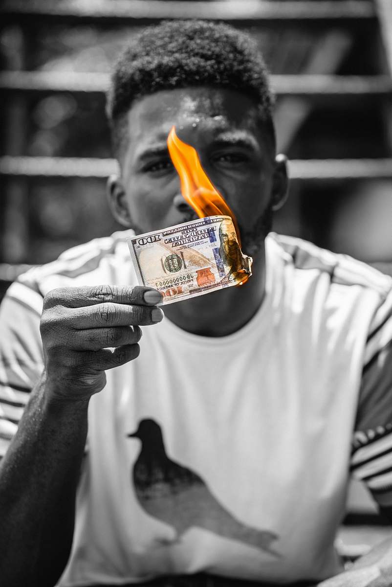 person man in white crew neck t-shirt holding orange and white carton houston