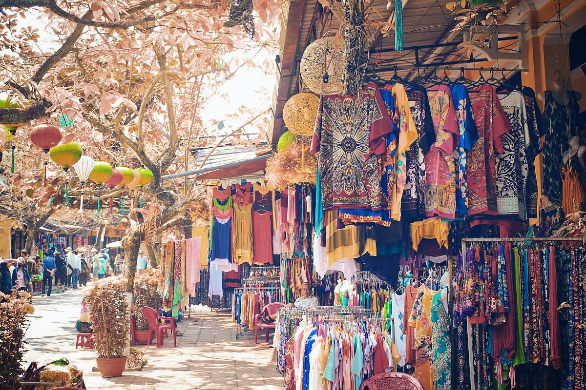 shop assorted clothes hanged on clothes line during daytime bazaar