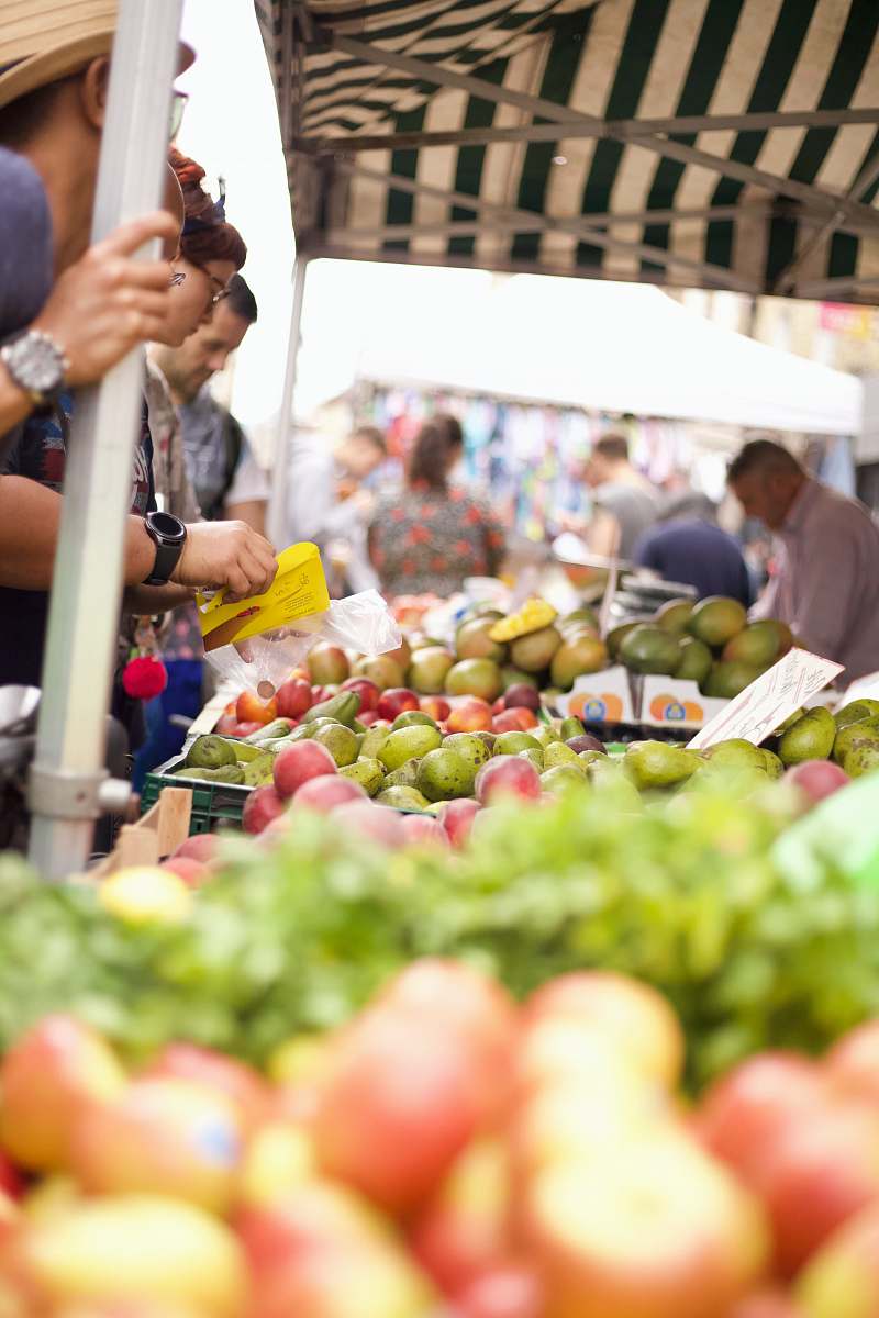 human photo of people buying fruits on stall person