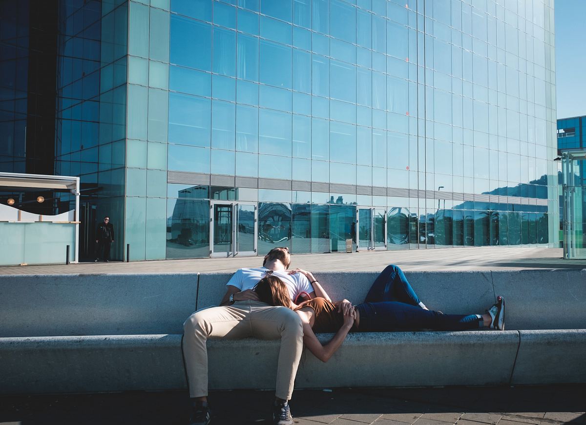 man and woman laying on concrete stairs