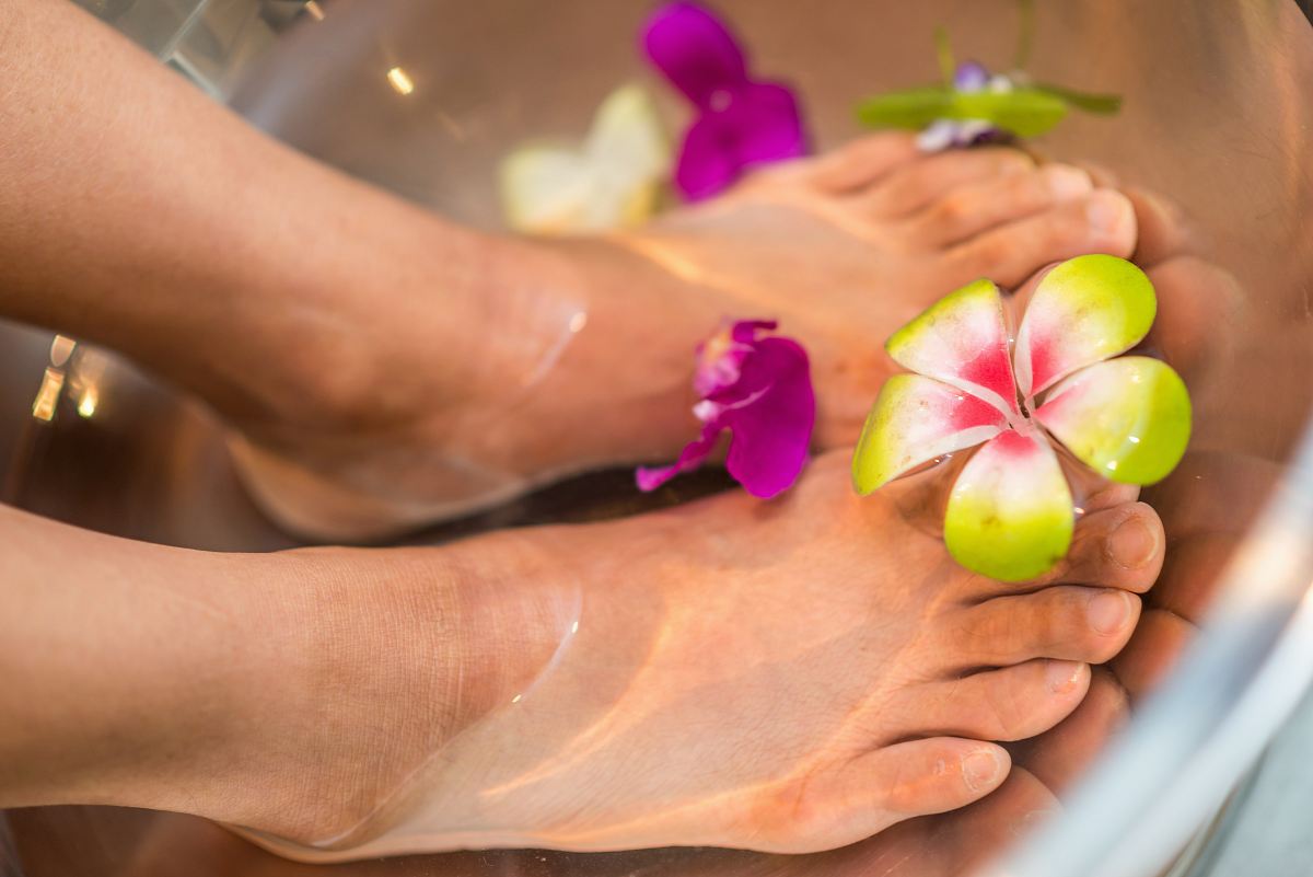 person's feet with flowers