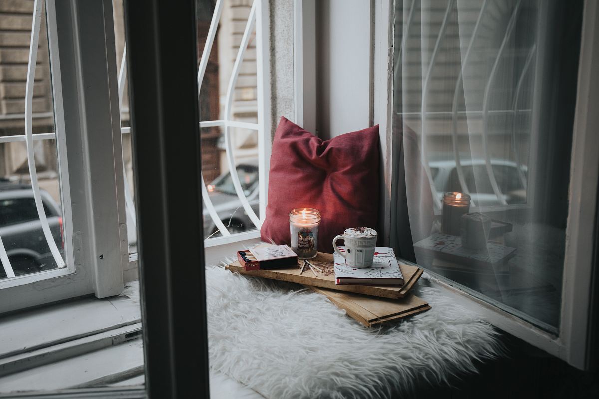 photo of gel candle on board beside pillow