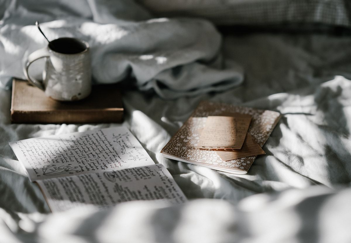 white mug beside white paper