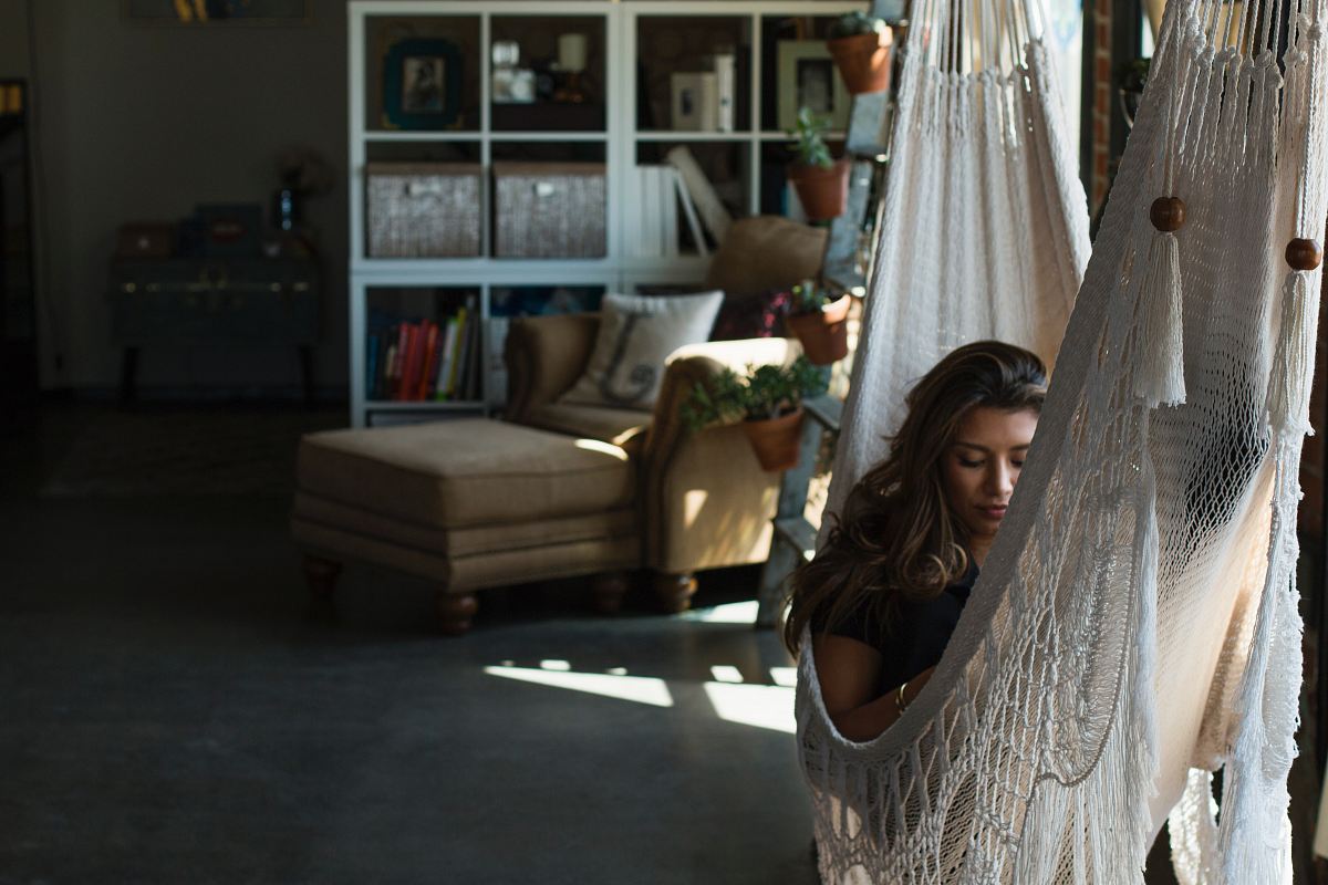 woman on white knit hammock during daytime
