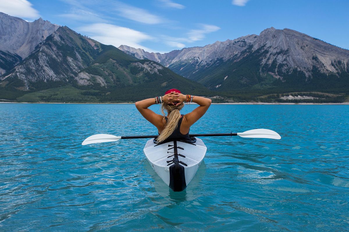 woman riding kayak at the middle of the sea