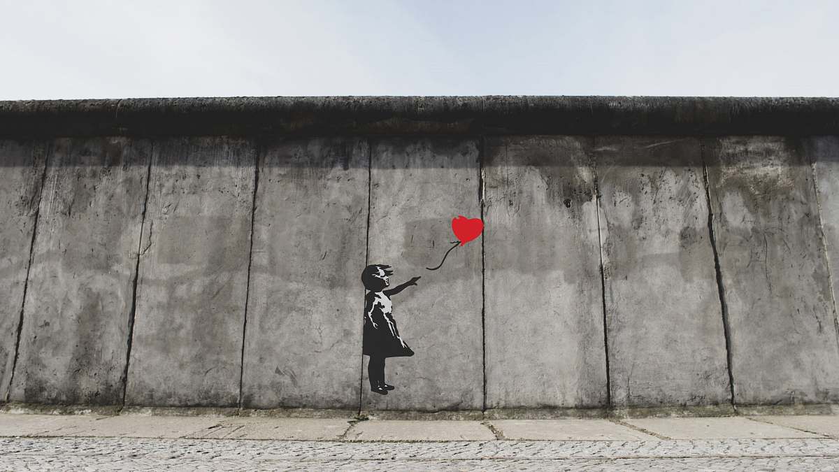 berlin girl playing heart balloon wall artwork germany