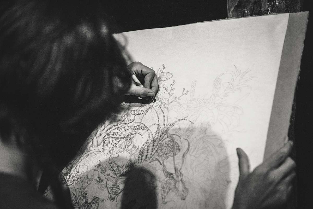 grey grayscale photo of a woman drawing a flowers black-and-white