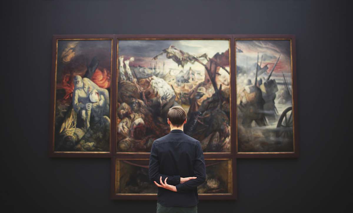 people man hands on back looking on painting mounted at wall person