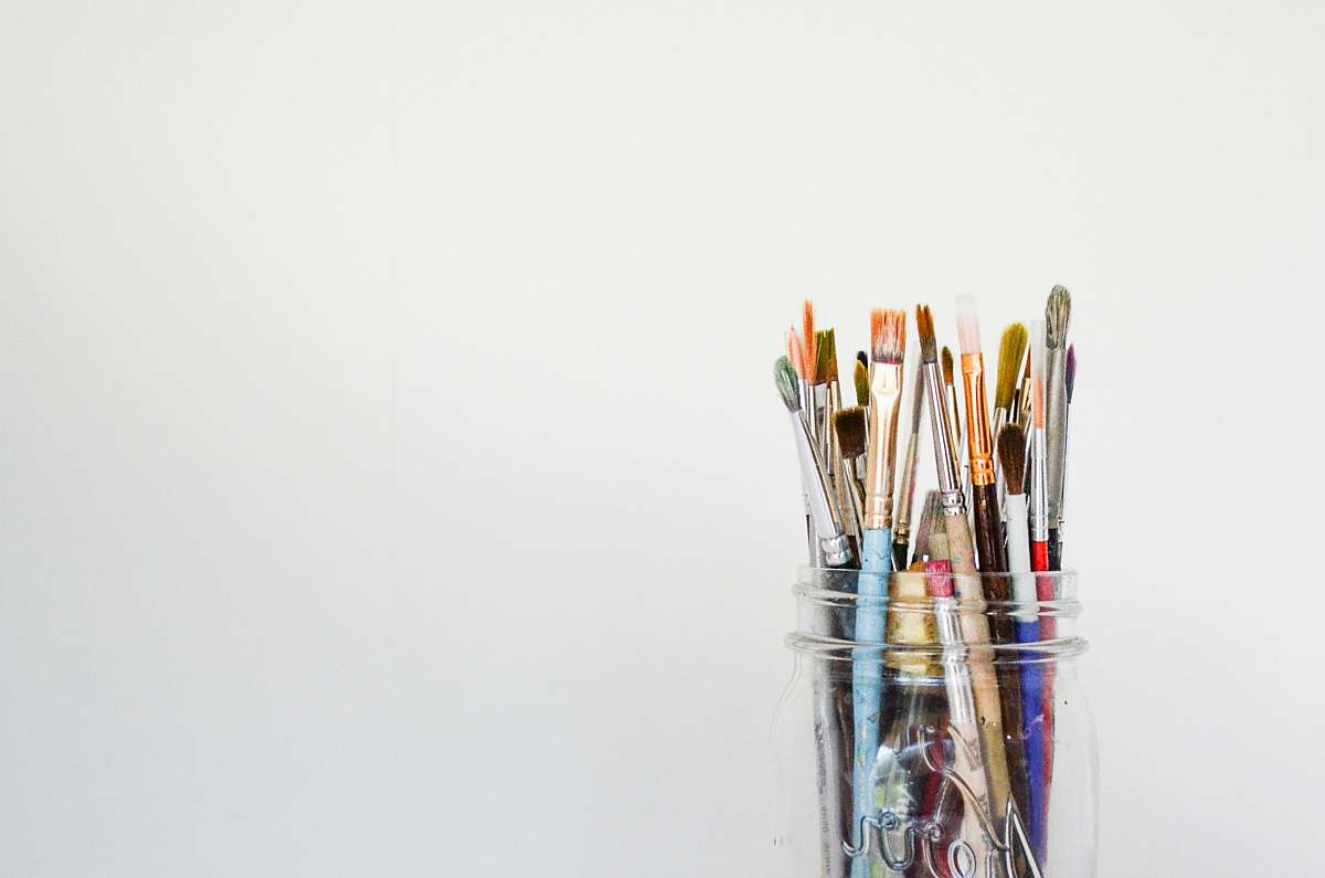 background mason jar of paintbrush lot artist