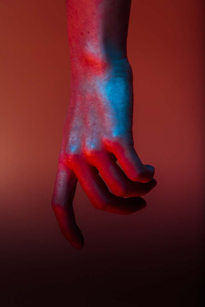 hands shallow focus photography of hand with red paint hand