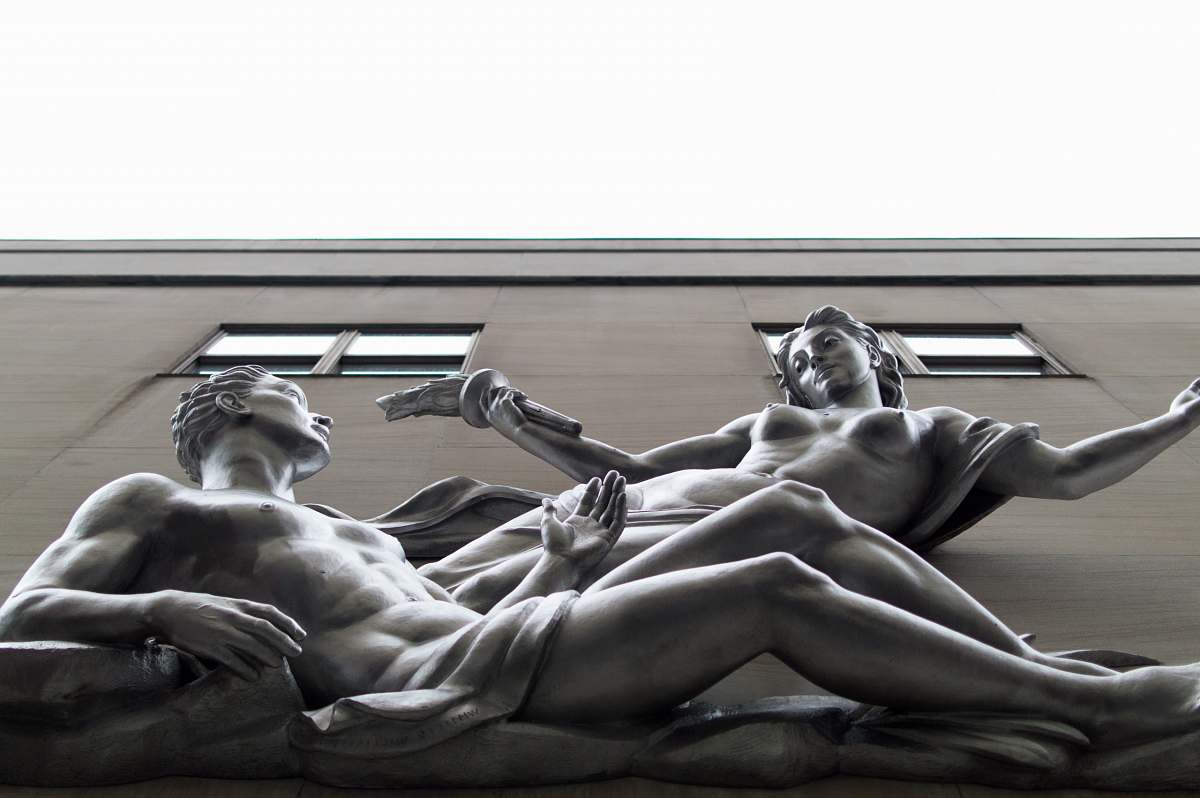 sculpture statue of nude woman and man on building human