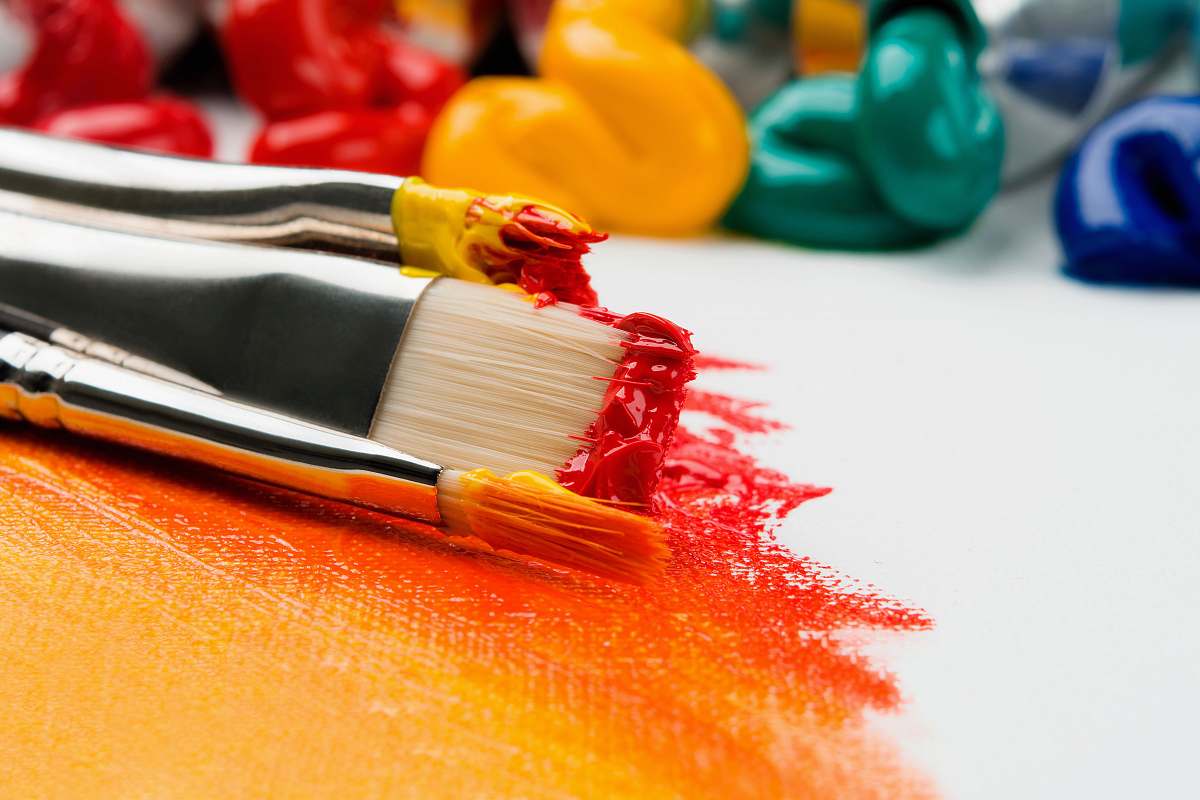 paint three silver paint brushes on white textile paintbrush