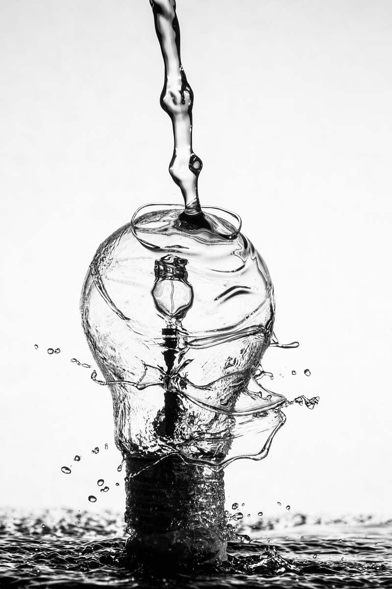 black-and-white water dropping on light bulb water