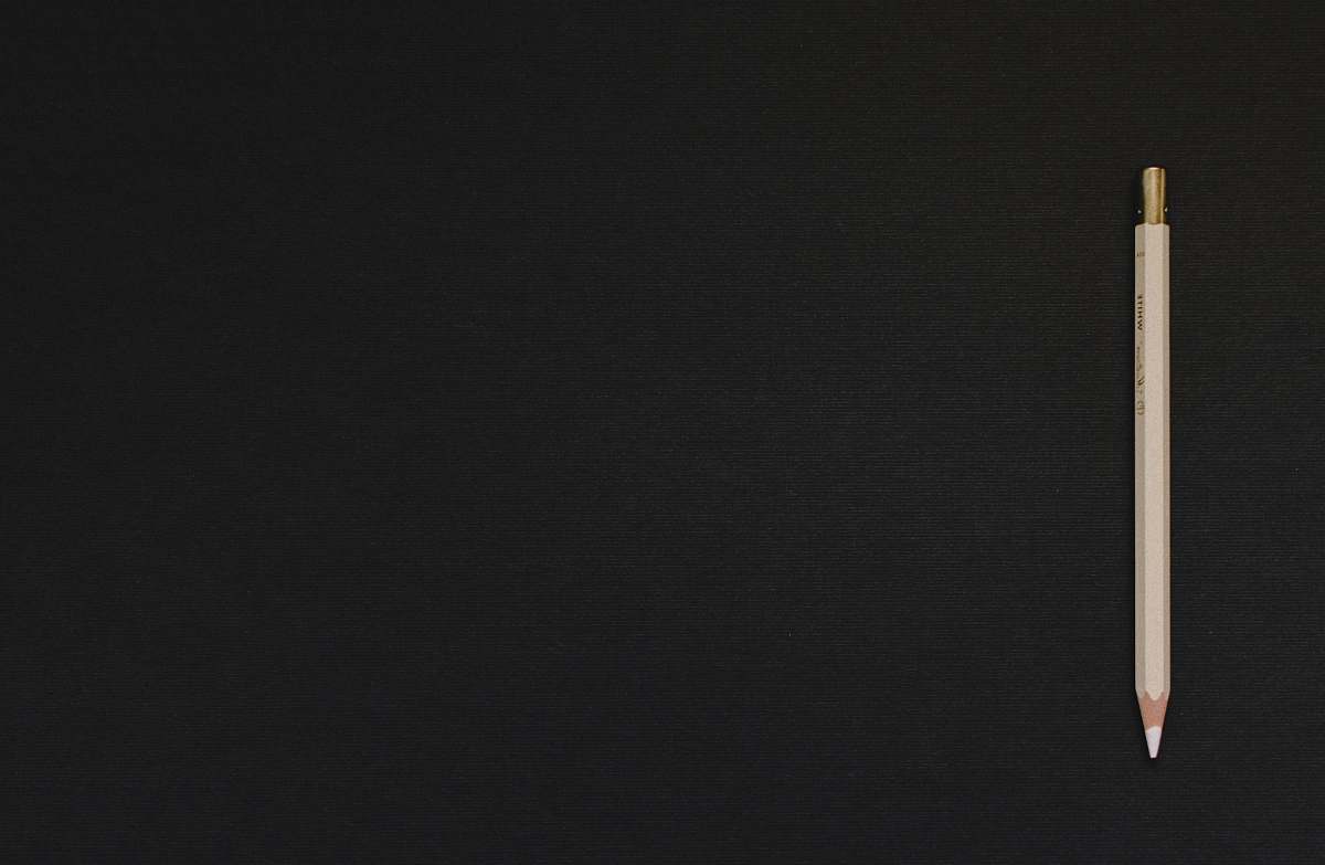 background white pencil on black platform writing