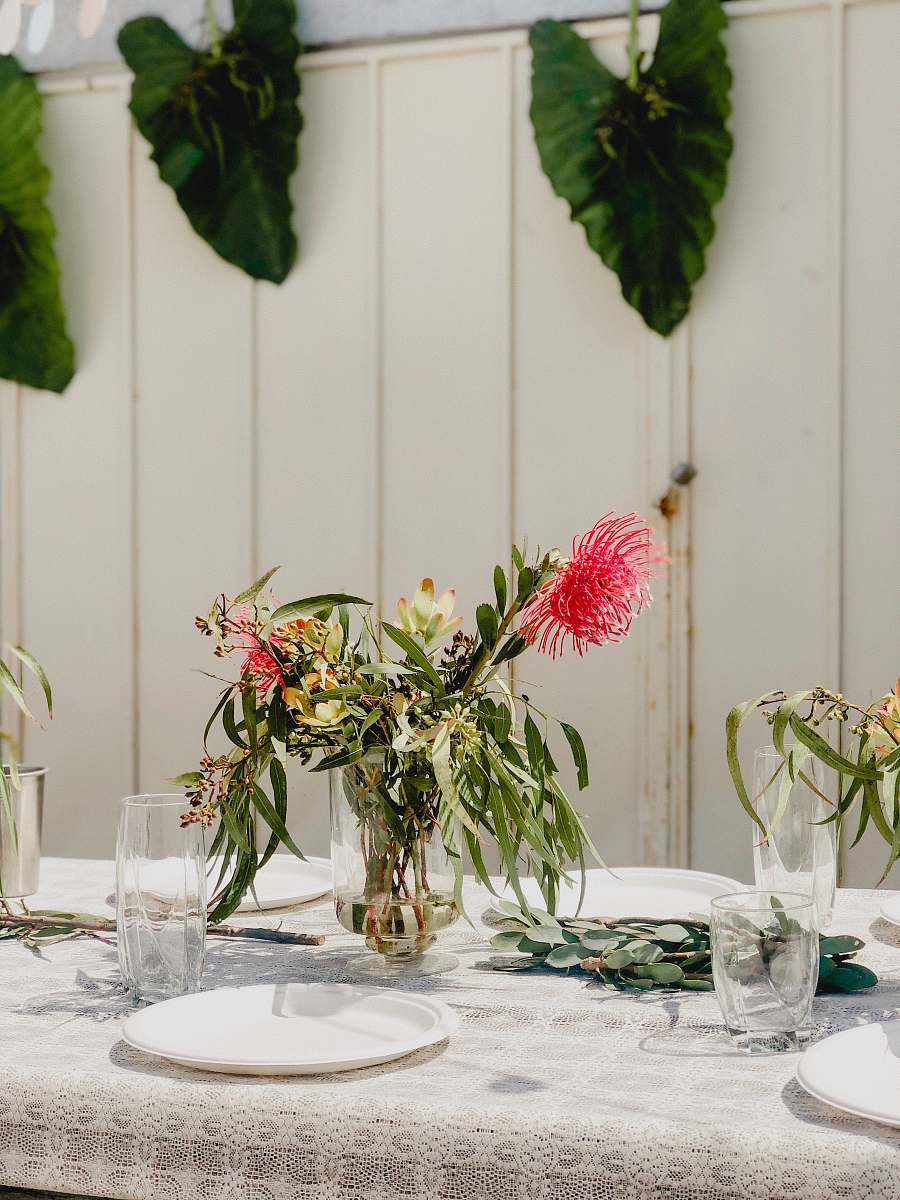 jar red-petaled flower on center table plant