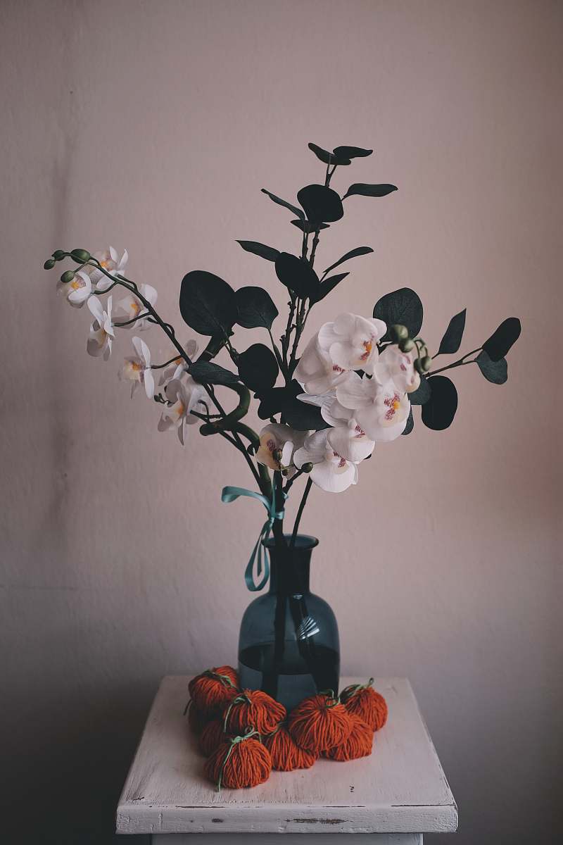 plant white flower bouquet inside blue glass vase vase