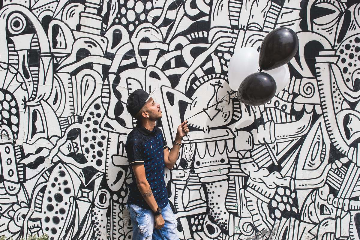 doodle man holding two black balloons human