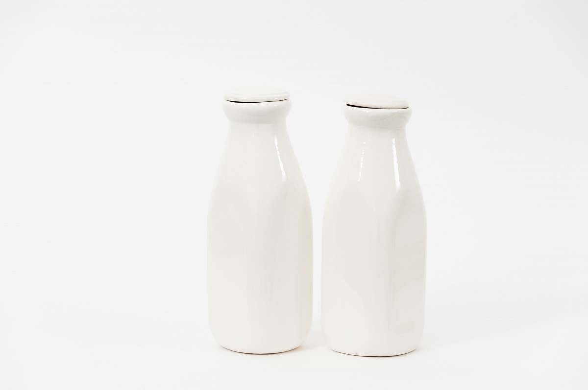 pottery two white milk bottles grey