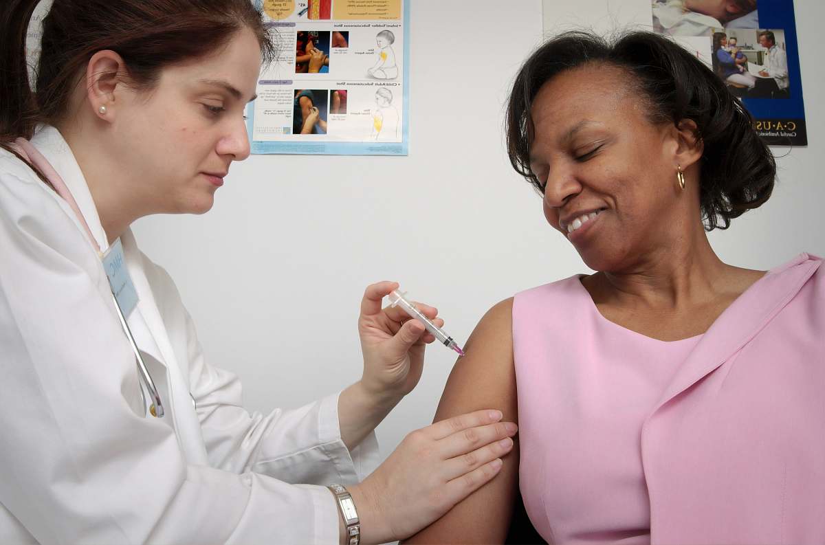 human woman getting vaccine injection
