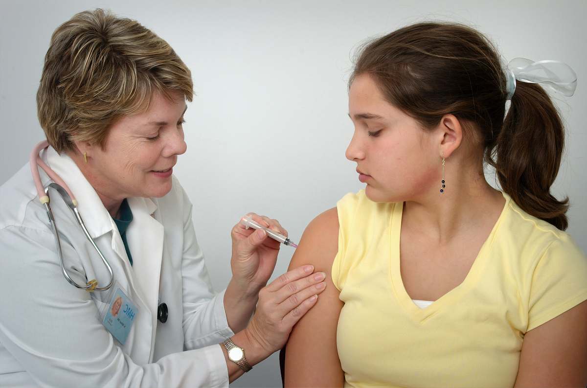 human woman injecting girl's left arm injection