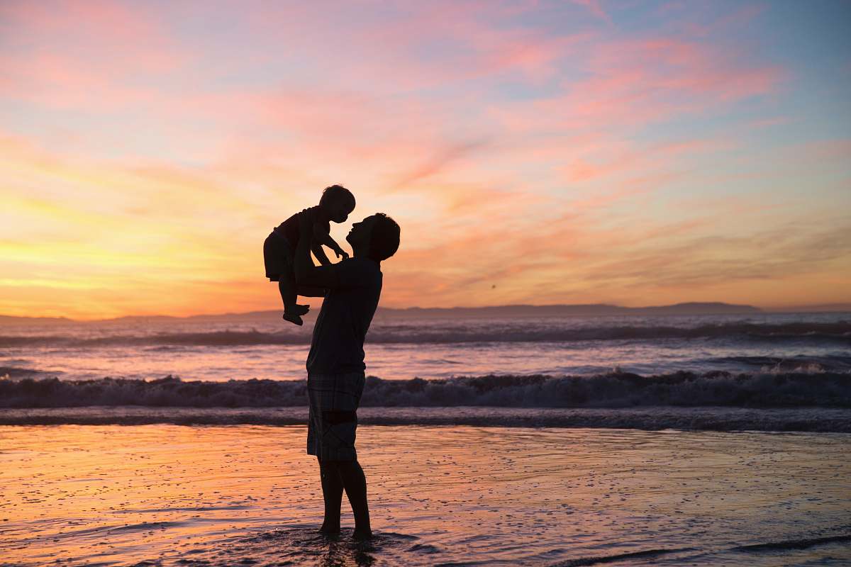  silhouette of man and kid 