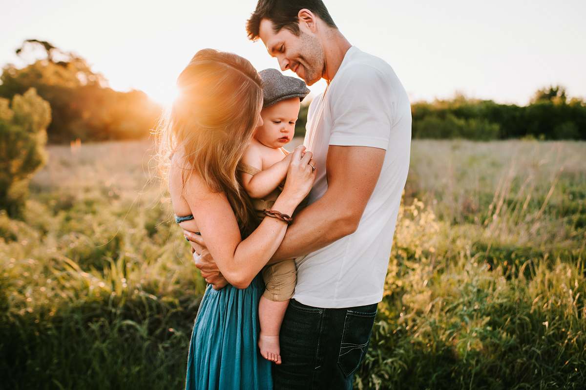 family family photo on green grass during golden hour person