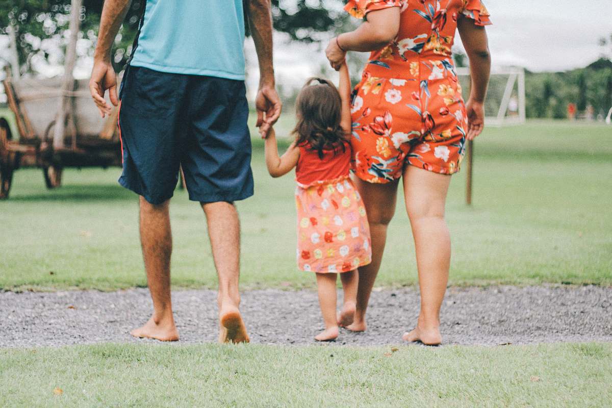 family man and woman holding their daughter person