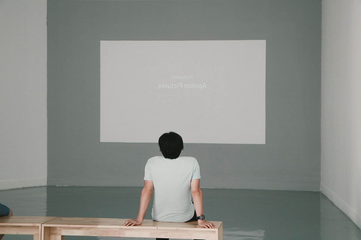 man sitting on bench inside room