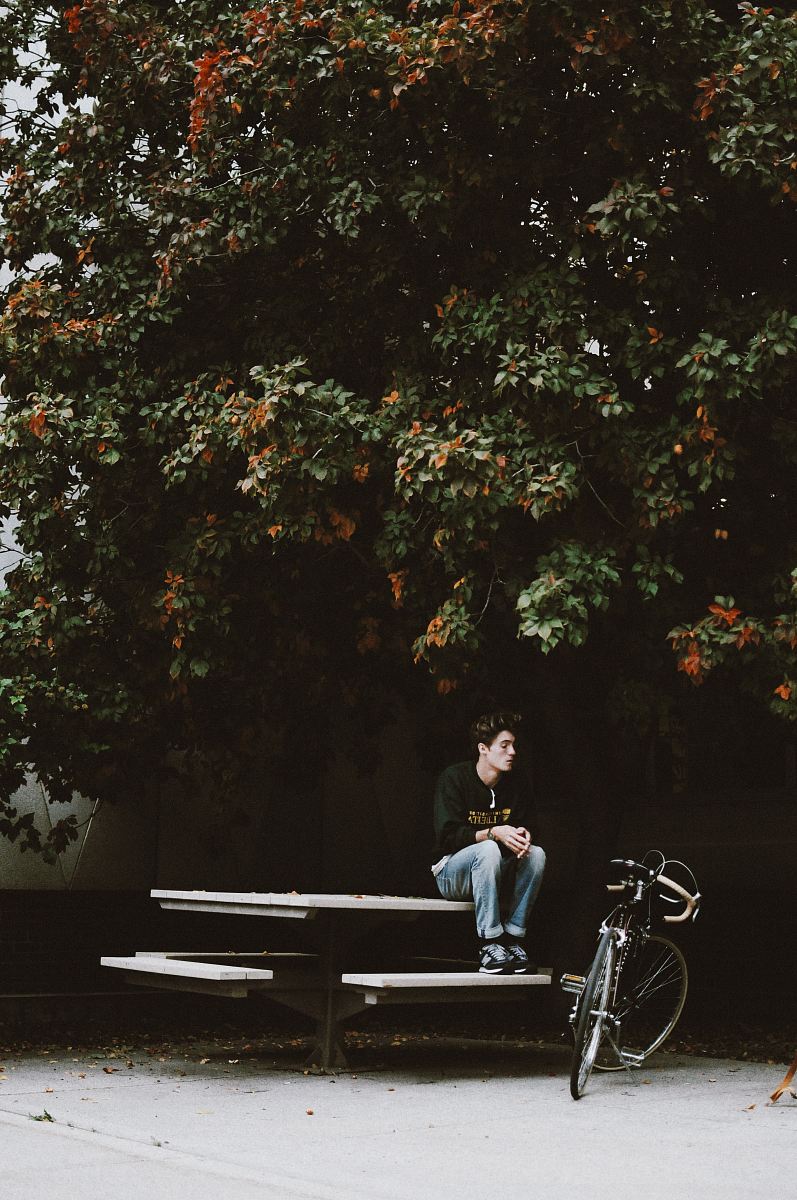 men sitting on picnic table