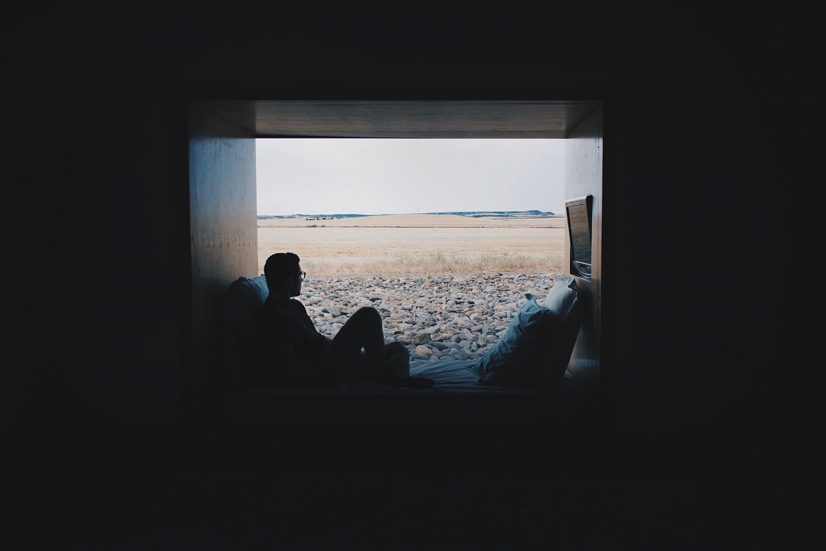 person sitting while looking outside