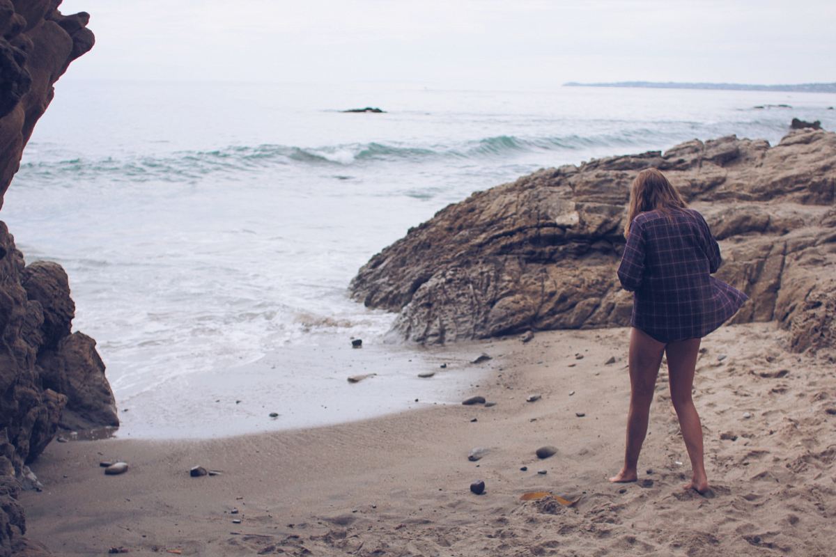 Woman on vacation steps out of the cove to relax in the beach shores
