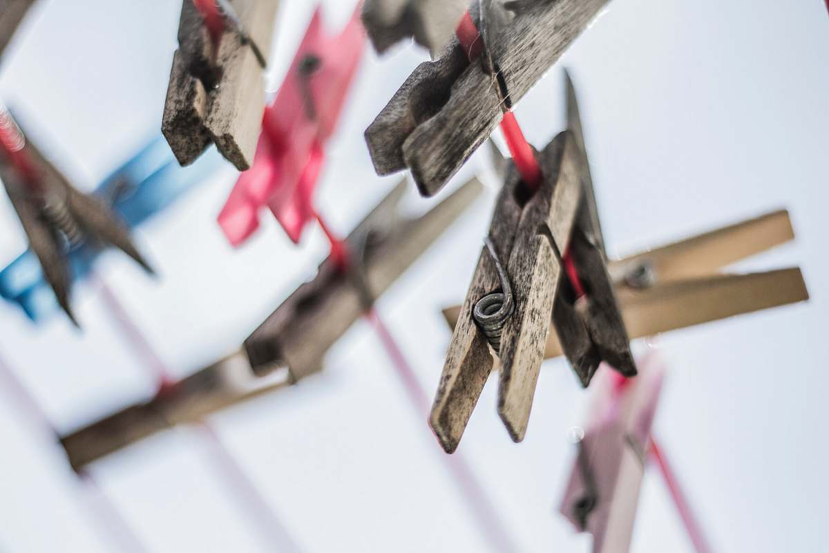 clothesline shallow focus photography of brown clothes pins pin