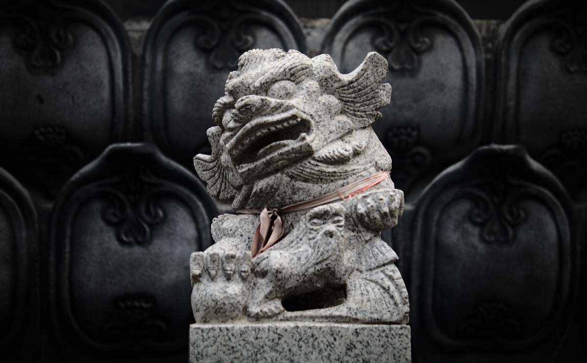 art gray Foo dog statue across sculpture