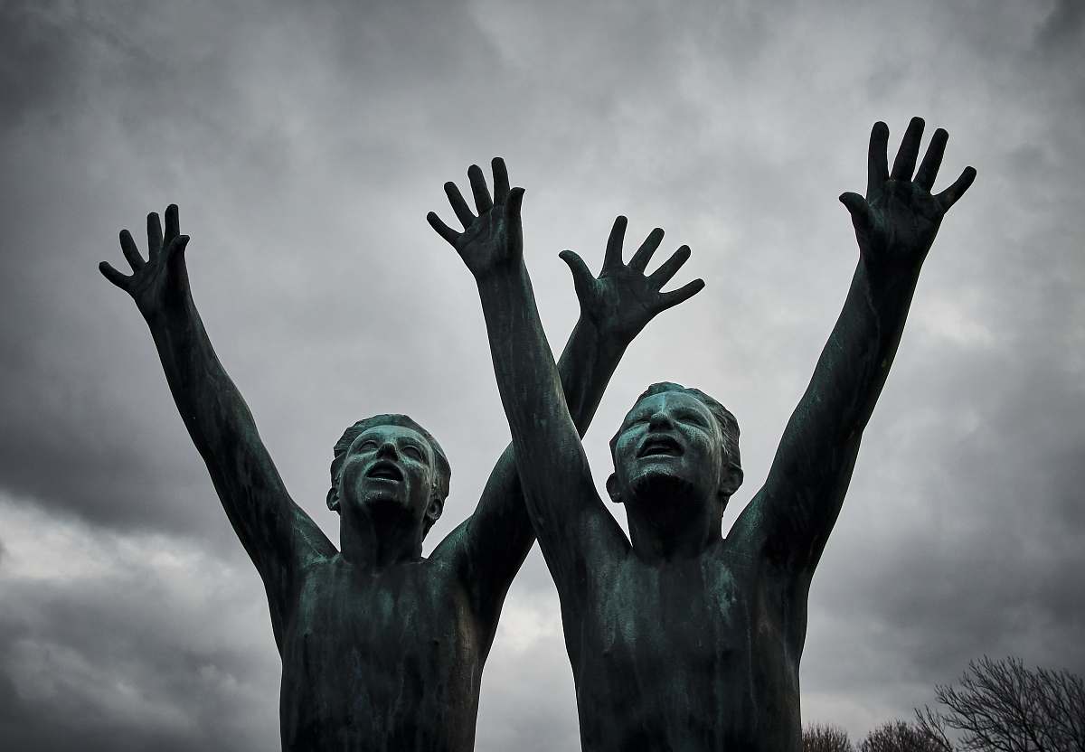 art two man raising their hands sculpture