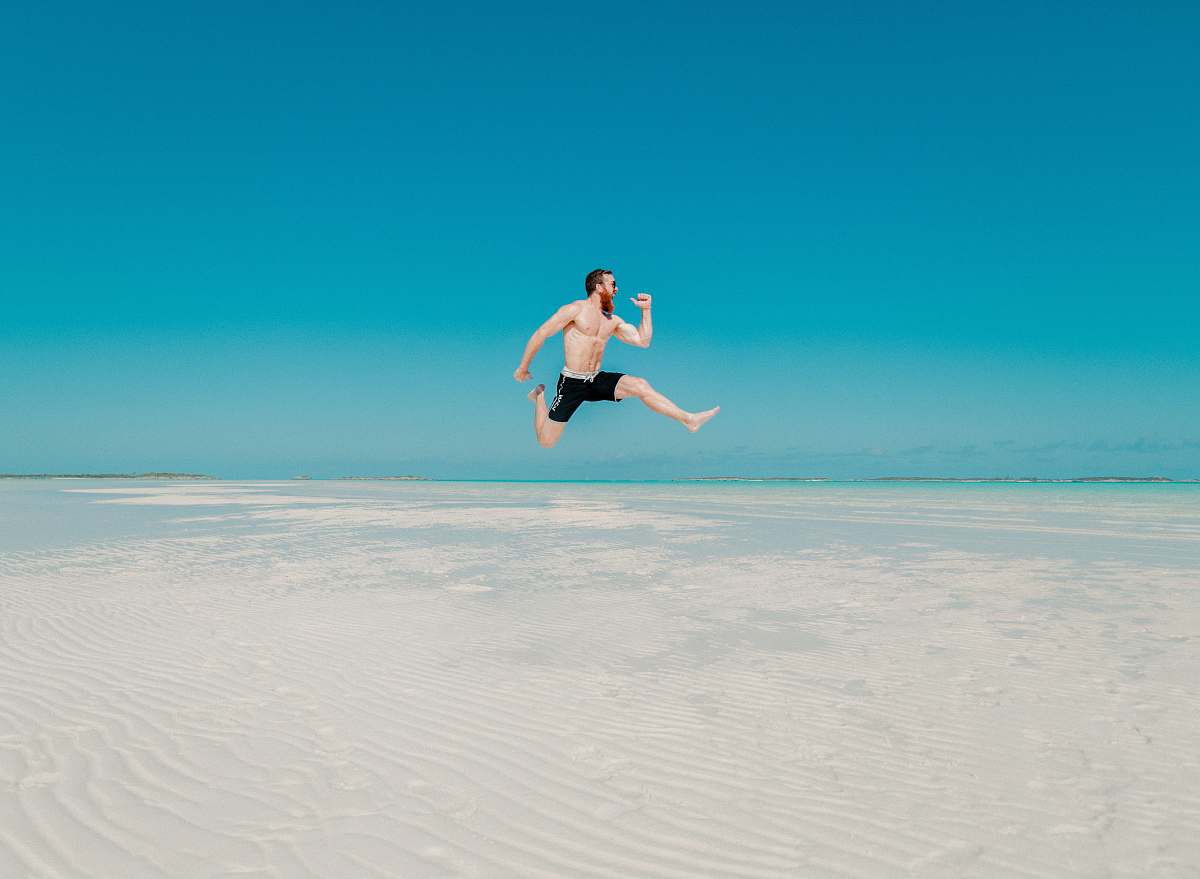 human time lapse photography of man jumping at seashore person