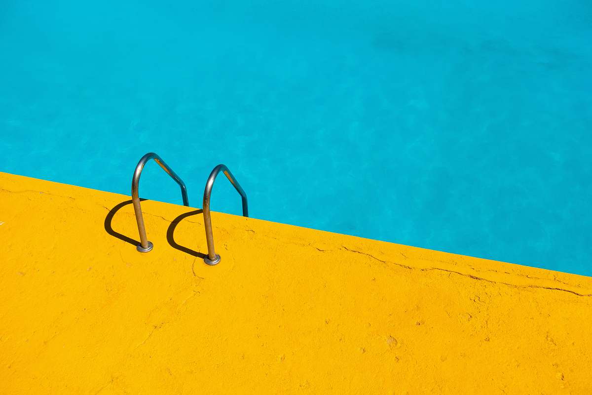 yellow swimming pool with stainless steel ladder color