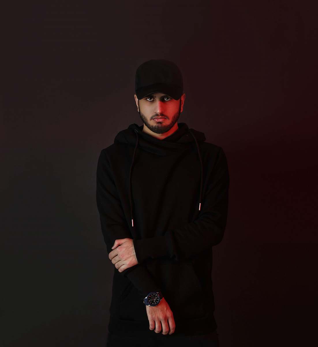 clothing man in black hoodie standing beside wall sleeve