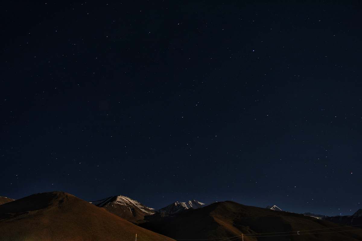 astronomy aerial photo of mountain tops starry sky