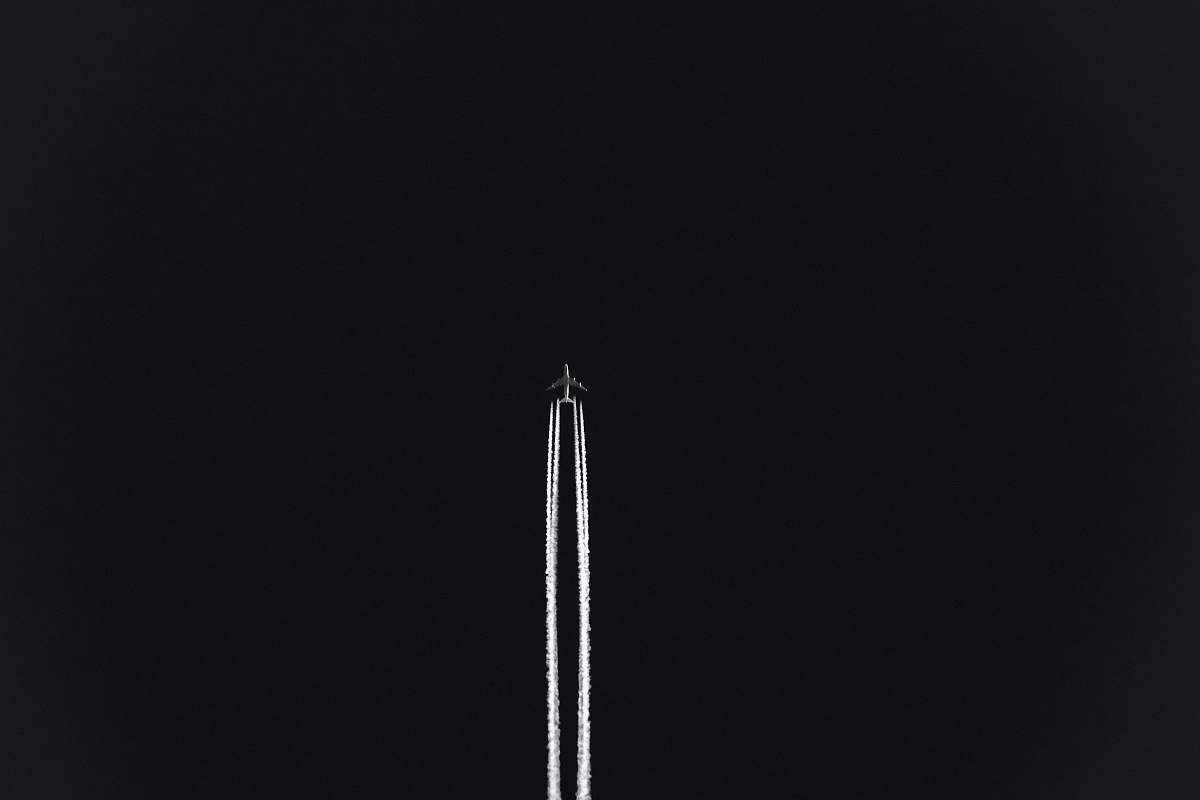 black airplane with white smoke backgrounds