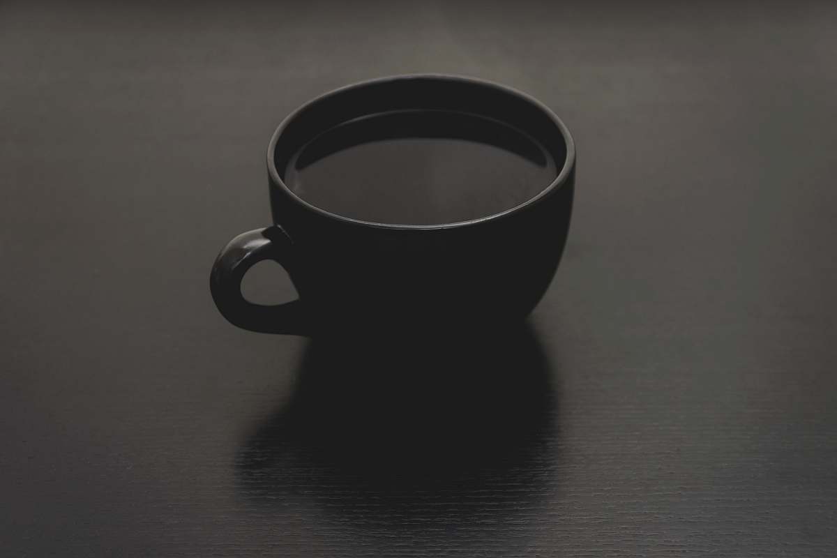 black black ceramic mug with liquid close up photo cup