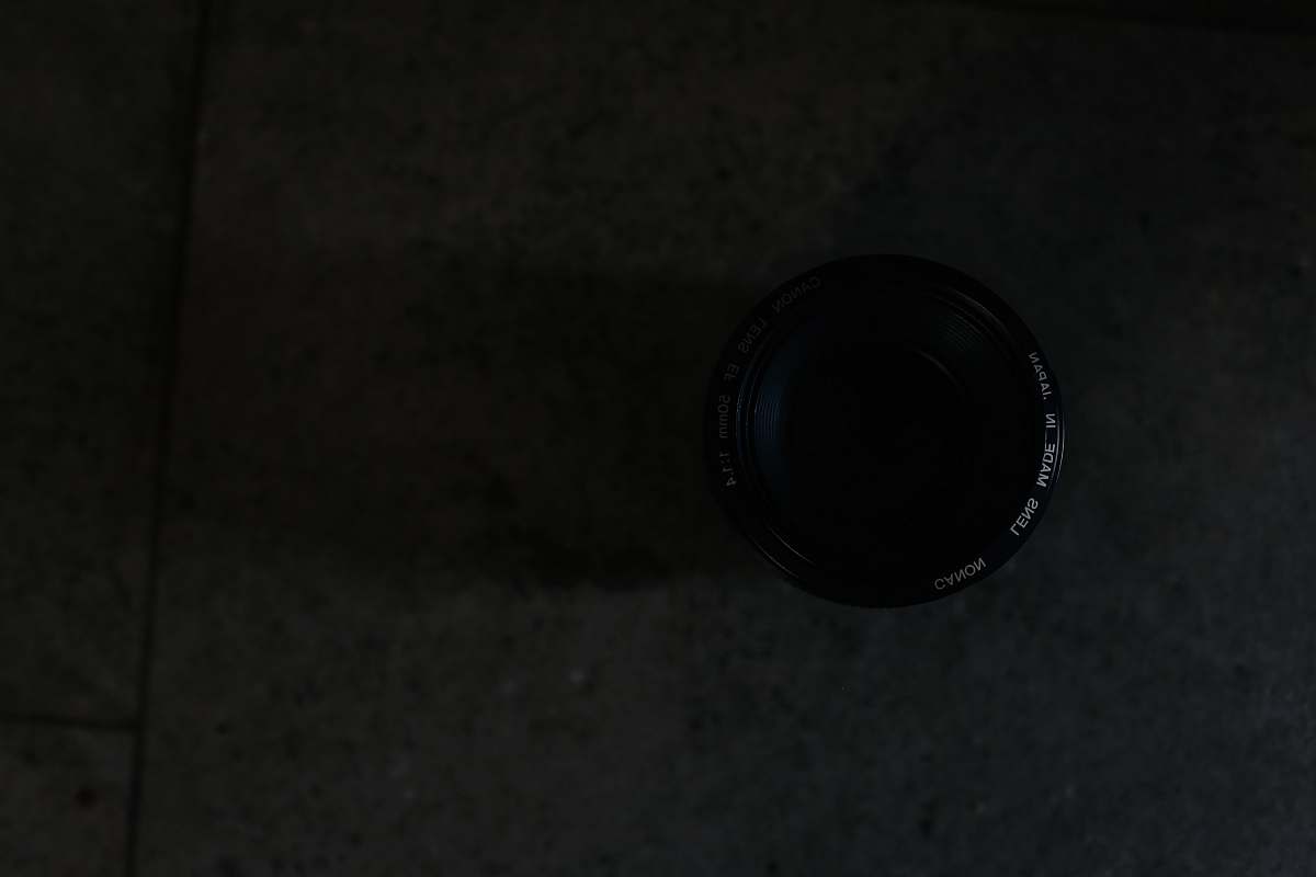 black closeup photography of camera lens on floor tile lens
