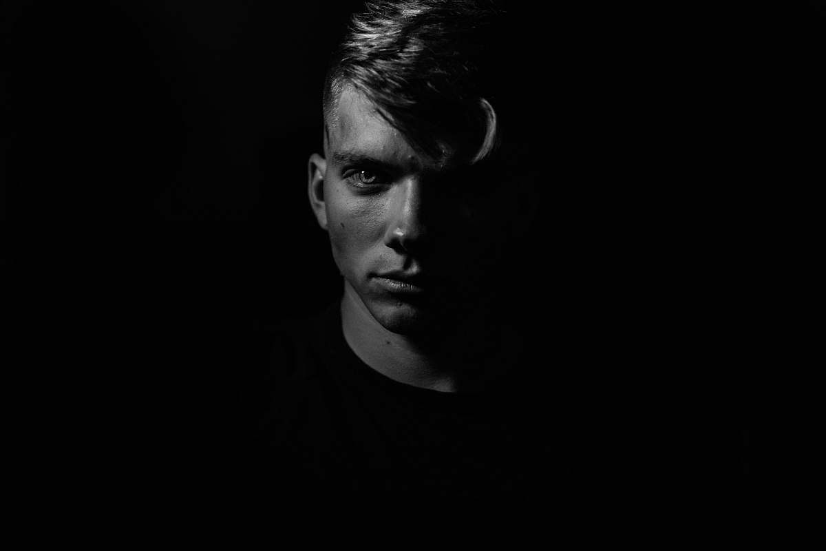 portrait grayscale man in dark room black