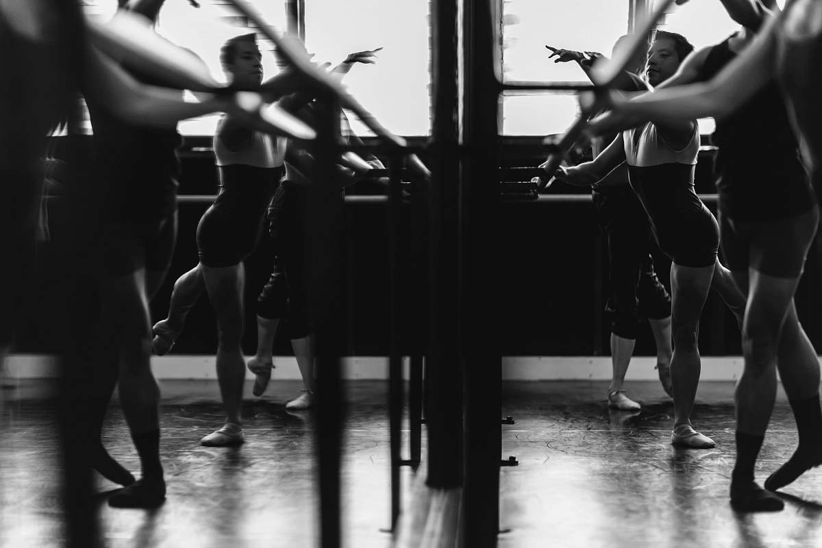 person grayscale photo of womens exercising in front of mirror dance