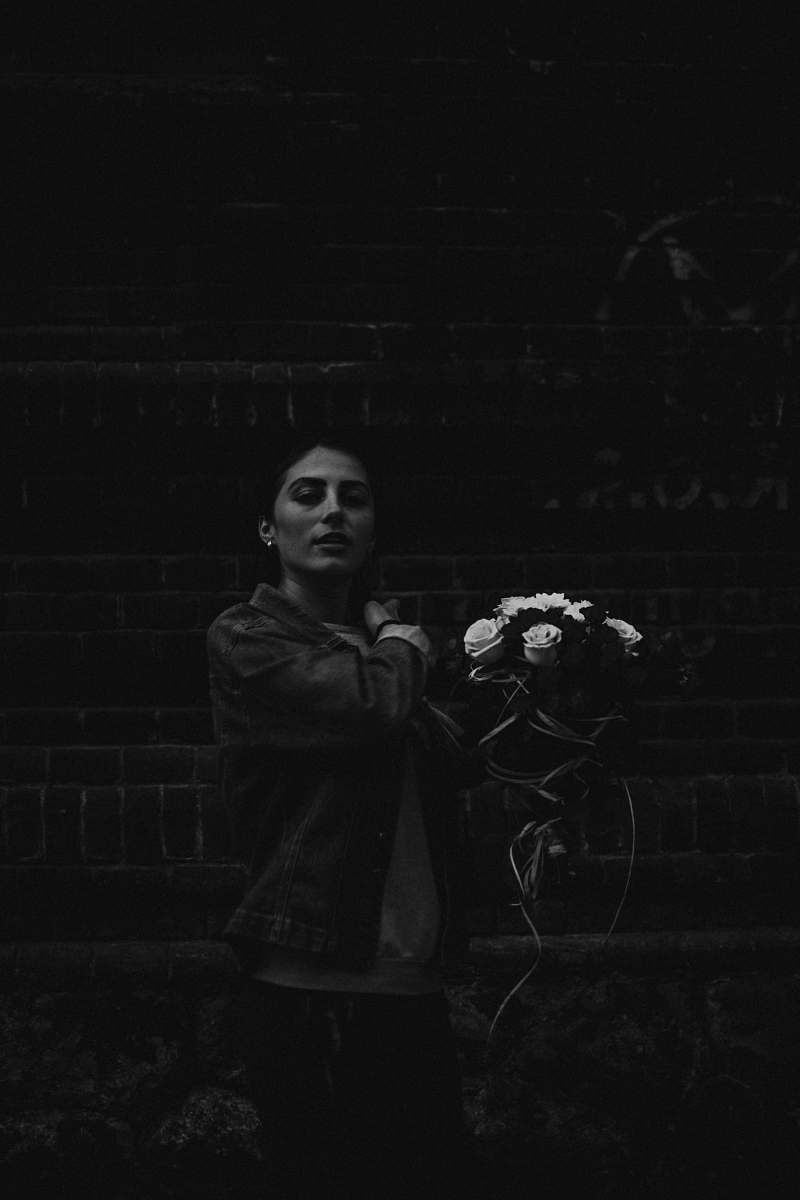 black grayscale photography of woman holding flower bouquet human
