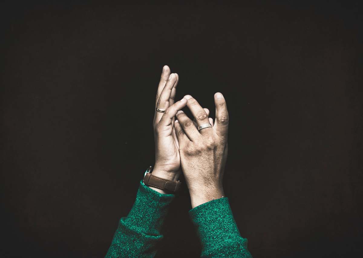 people closeup photo of person raising both arms hands