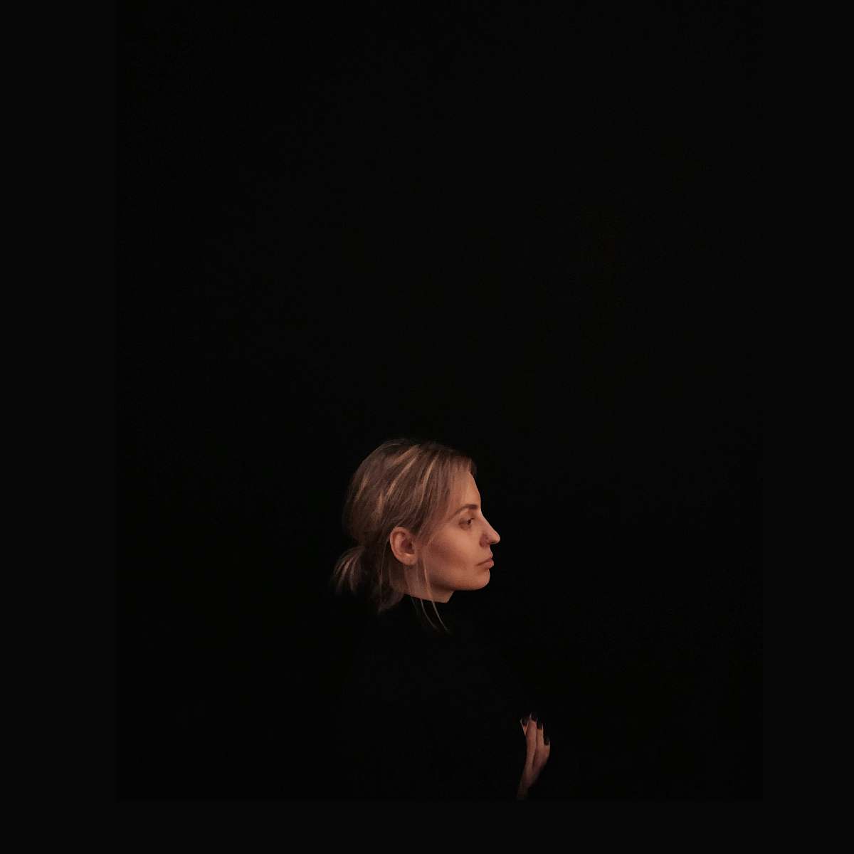 person minimalist photography of woman wearing black top facing to the side human