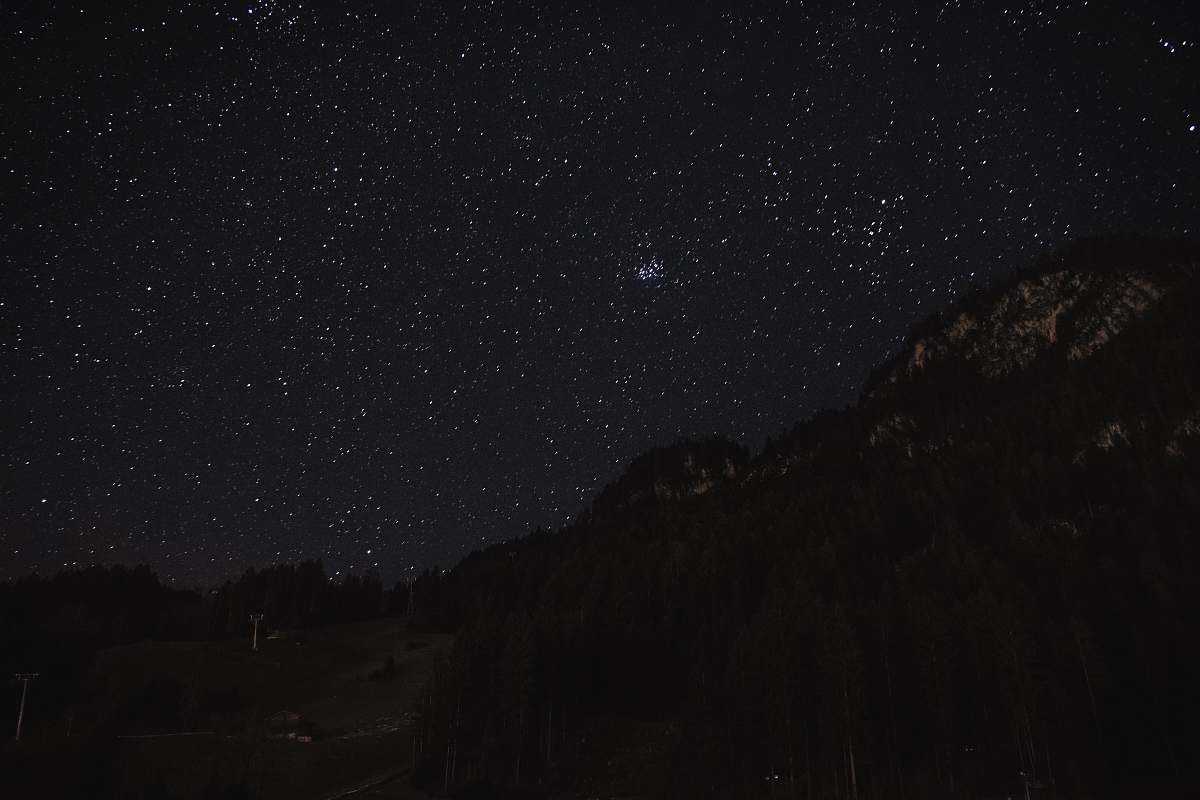 astronomy silhouette photo of mountains night