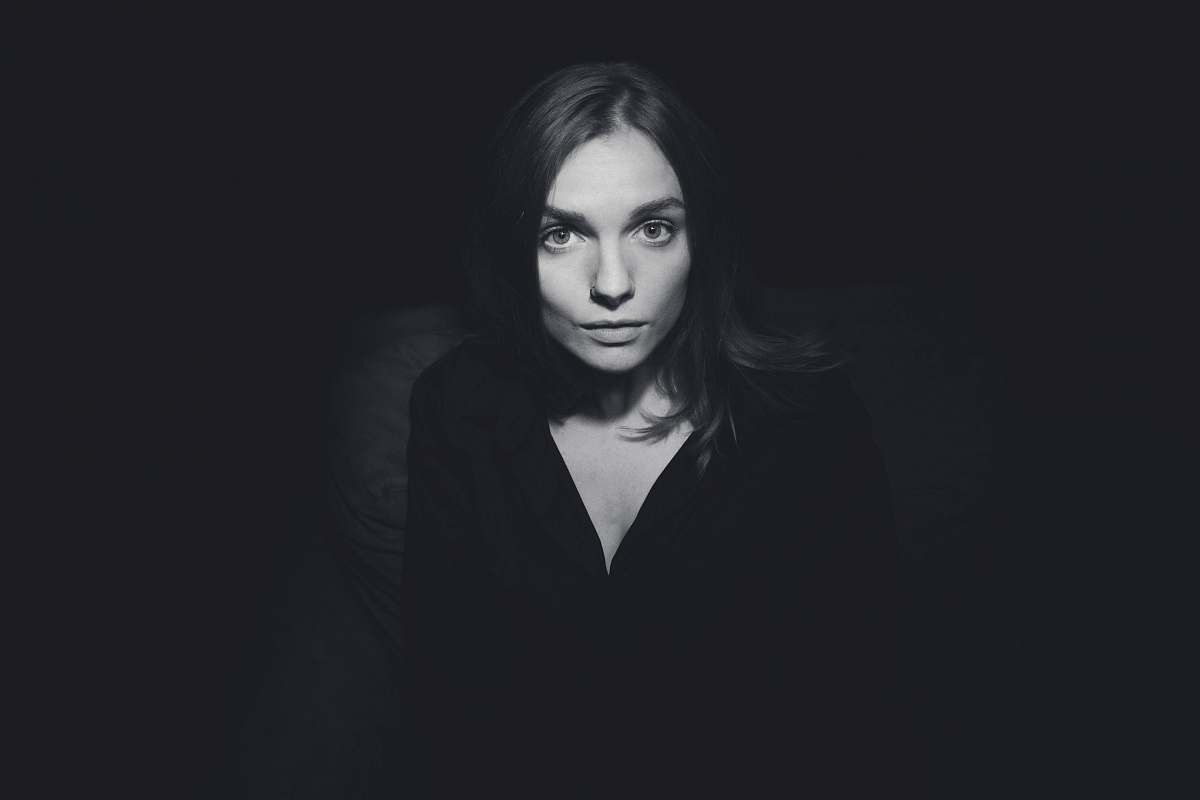 person grayscale photography of woman wearing plunging-neckline top people