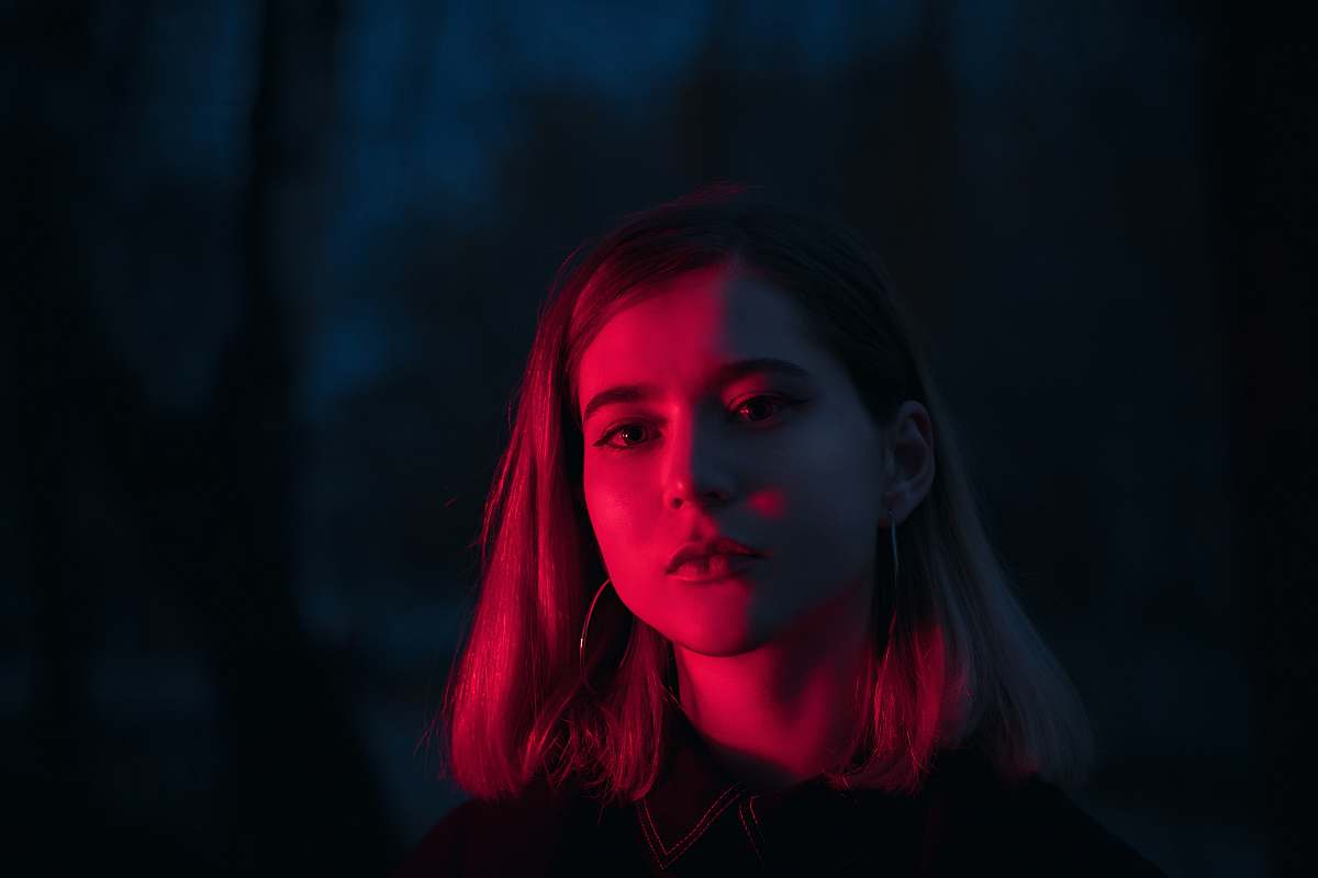 person red lighting on woman's face at night black