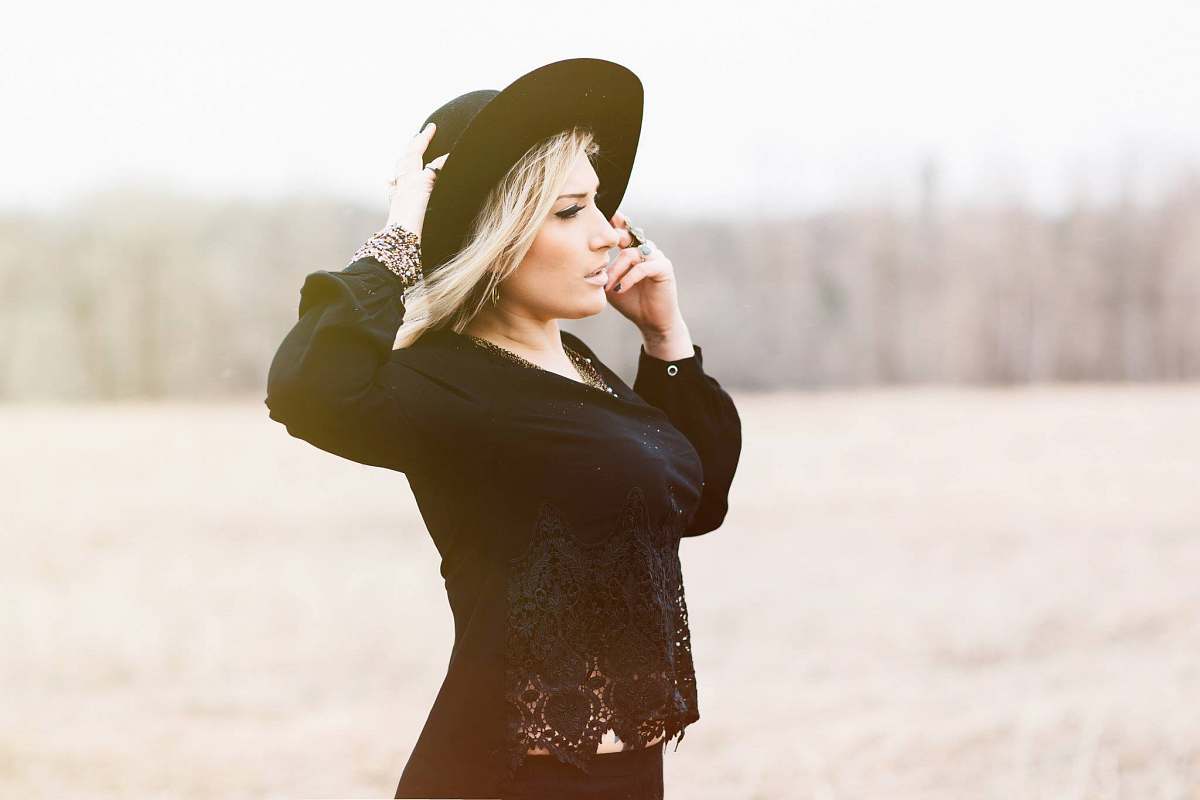 woman woman holding black hat hat